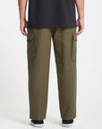 Person wearing olive green Volcom cargo pants on a white background