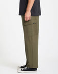Person wearing olive green cargo pants on a white background