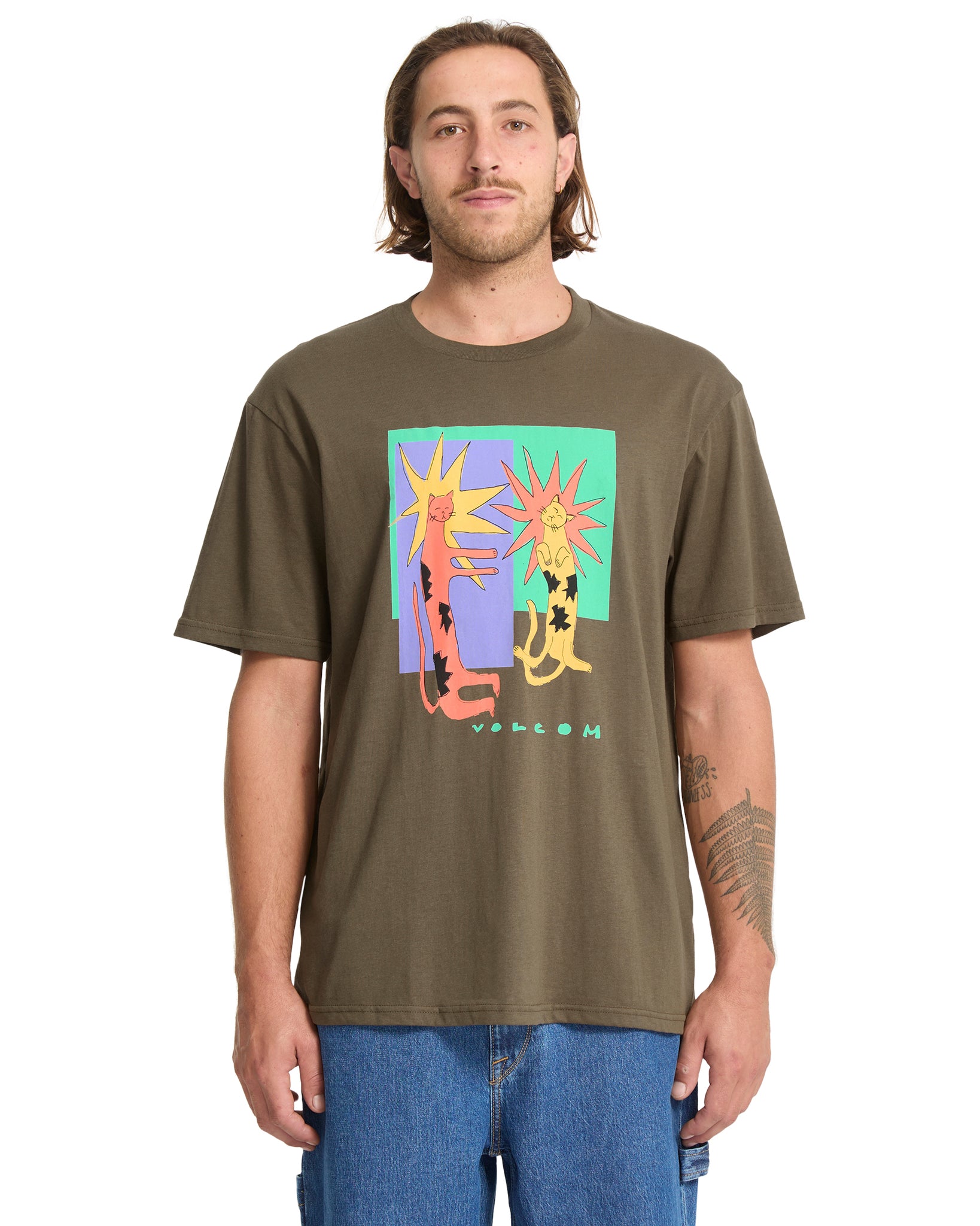 Man wearing a brown t-shirt with a colorful graphic design on a white background