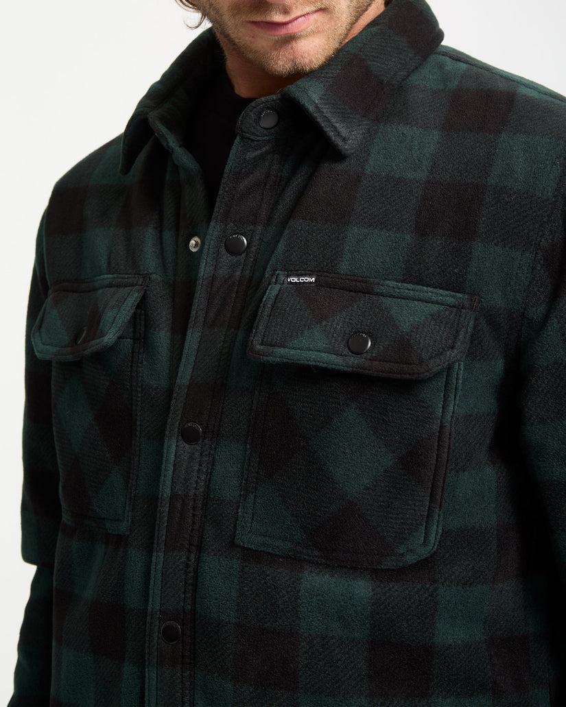 Green and black checkered shirt with brand logo on a white background
