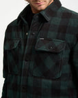 Green and black checkered shirt with brand logo on a white background