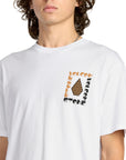 Person wearing a white t-shirt with Volcom graphic design