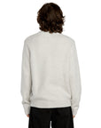 Person wearing a light gray sweater on a white background