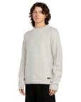 Person wearing a light gray sweater on a white background