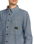 Blue denim Volcom shirt with a brand logo on a white background - available at Mango Surfing.