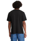 Person wearing a black t-shirt and blue jeans on a white background