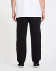 Person wearing black pants and a white shirt on a white background