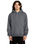 Person wearing a gray hoodie with a small logo on a white background