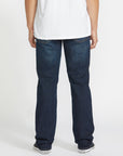 Person wearing blue jeans and a white shirt on a white background