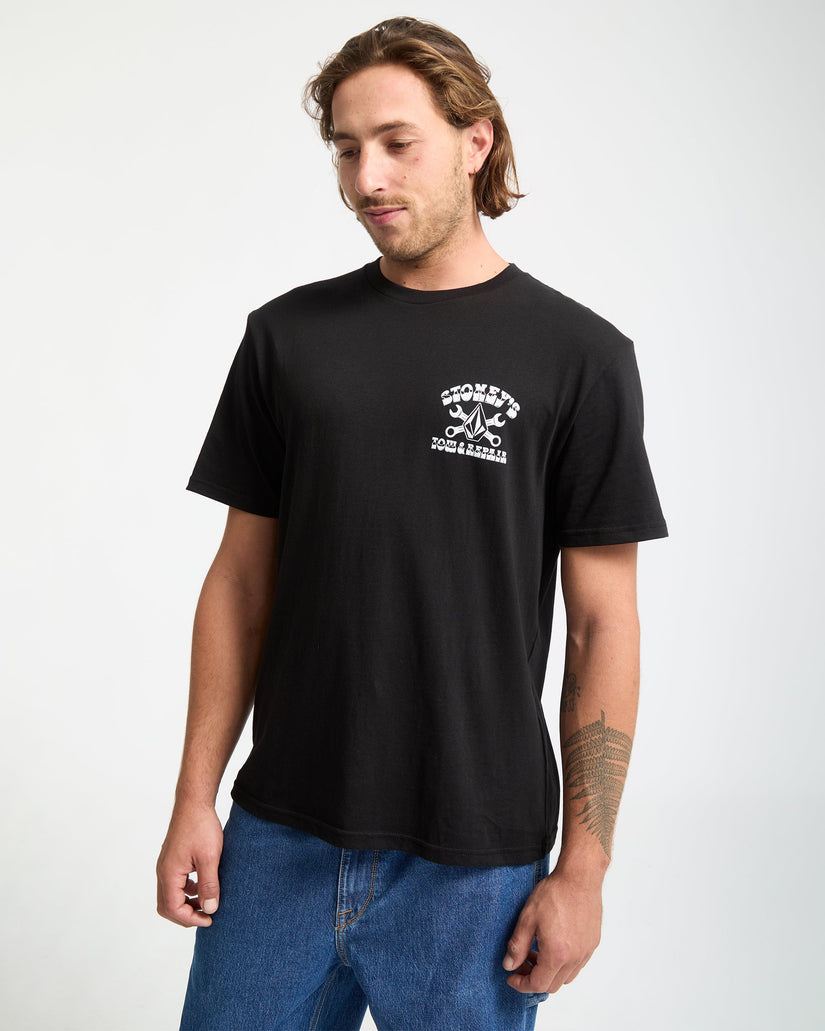 Man wearing a black t-shirt with a logo on a white background