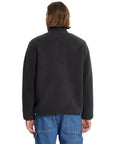 Person wearing a dark gray fleece jacket on a white background