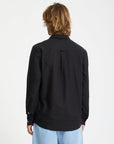 Person wearing a black shirt with a white background