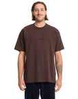 Man wearing a brown t-shirt with a logo on a white background