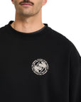 Black sweatshirt with a white Volcom logo on a white background