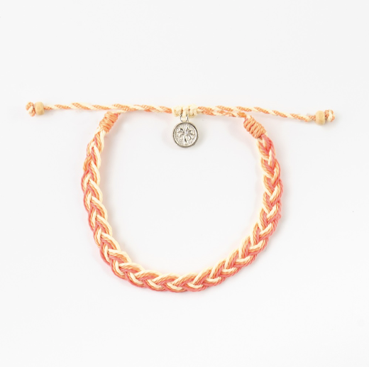 A braided cord bracelet in orange and cream, featuring a small silver-toned circular charm with a star design, displayed on a clean white background.
