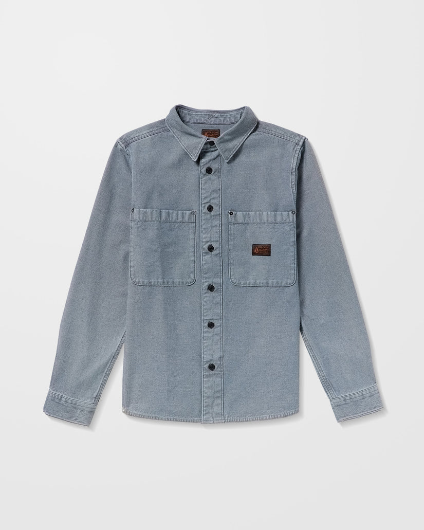 Light blue denim Volcom shirt on a white background, available at Mango Surfing.