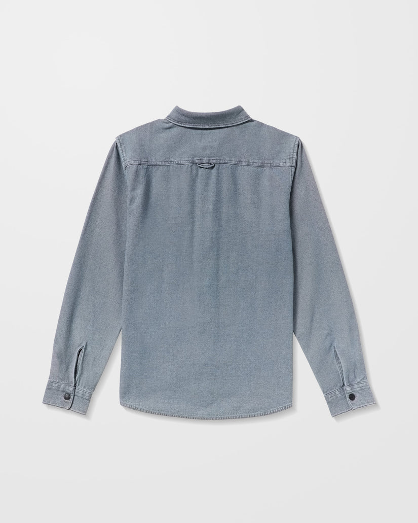 Blue denim Volcom shirt on a light gray background - available at Mango Surfing.