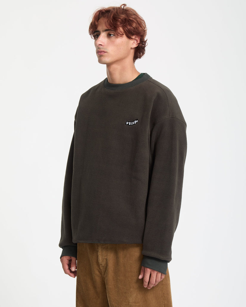 Man wearing a dark brown sweatshirt with a logo on a white background