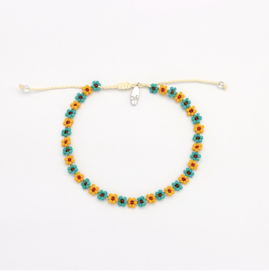 A beaded adjustable cord bracelet featuring repeating small flower motifs in teal, orange, and yellow, with a silver-toned clasp, displayed on a clean white background.